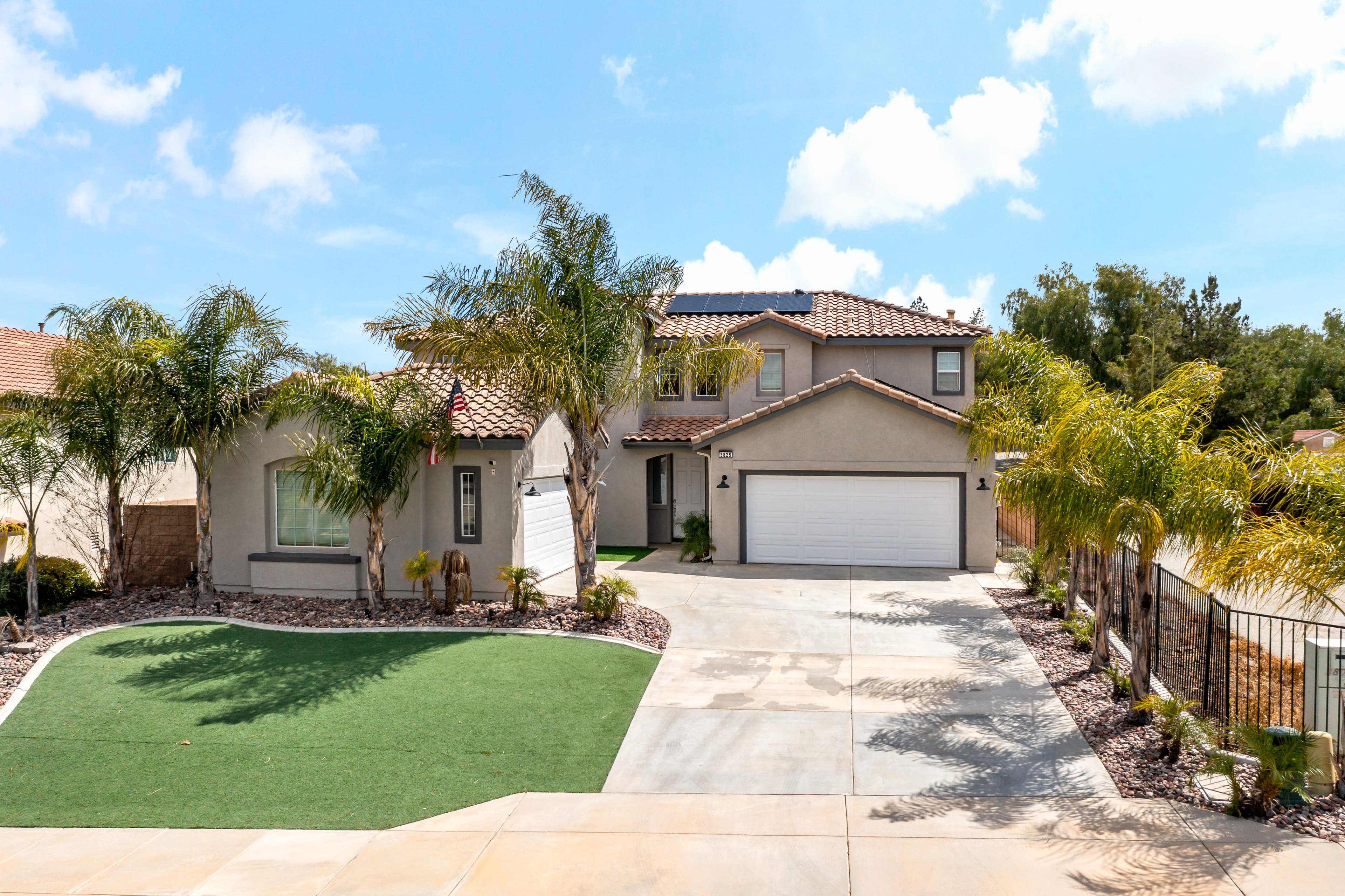 Street view of the Tanzanite Court property with the detached ADU beyond the gated side drive